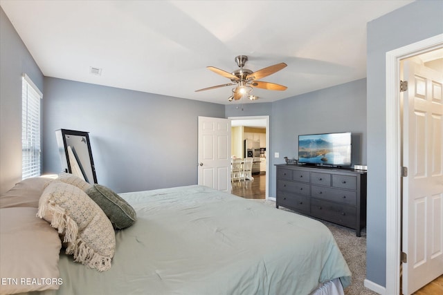 bedroom with baseboards, visible vents, and a ceiling fan