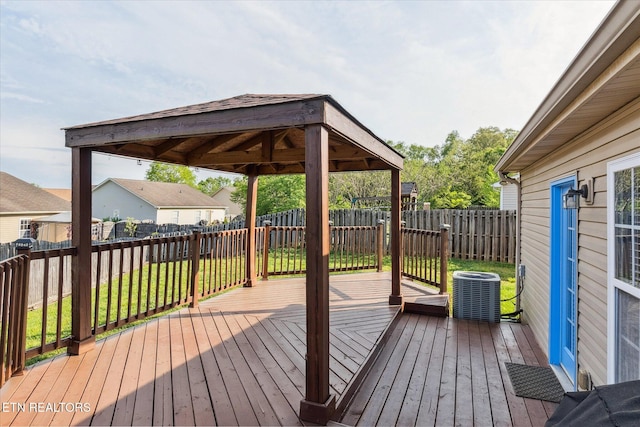 wooden deck featuring a yard, central air condition unit, a gazebo, and a fenced backyard