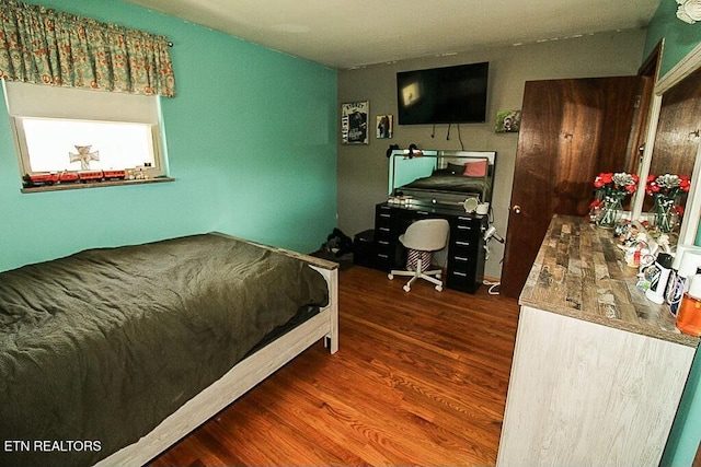bedroom featuring wood finished floors