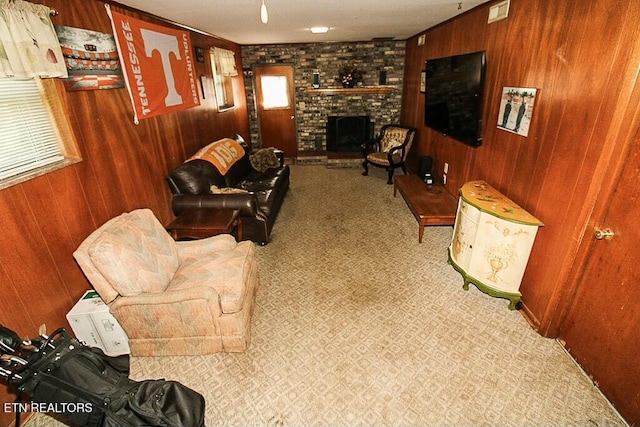 living area with wooden walls, visible vents, and a fireplace