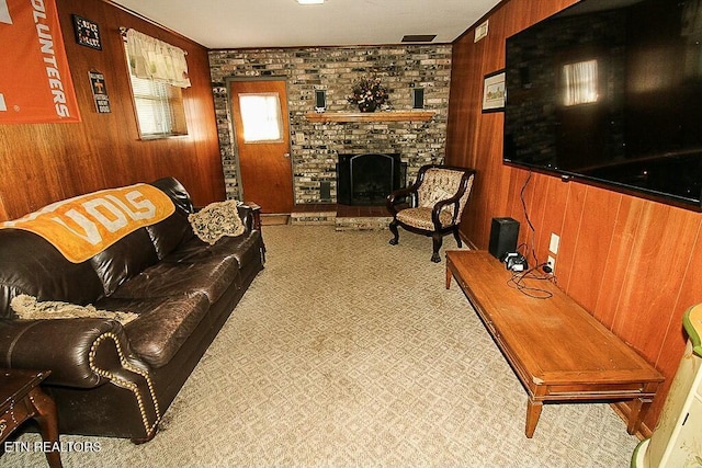 living area with wood walls, crown molding, and a fireplace