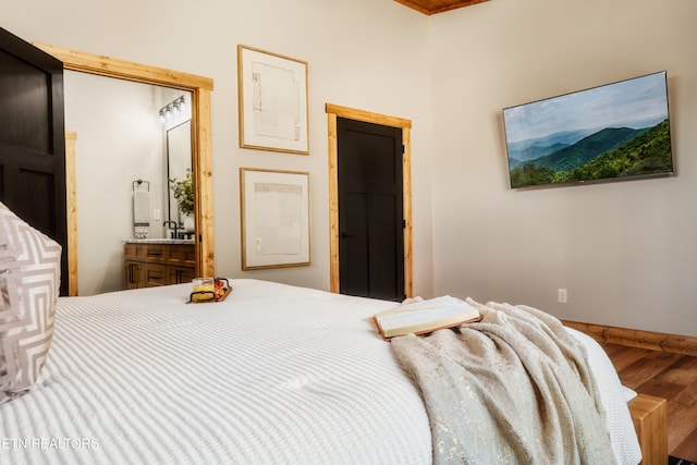 bedroom featuring wood finished floors and baseboards