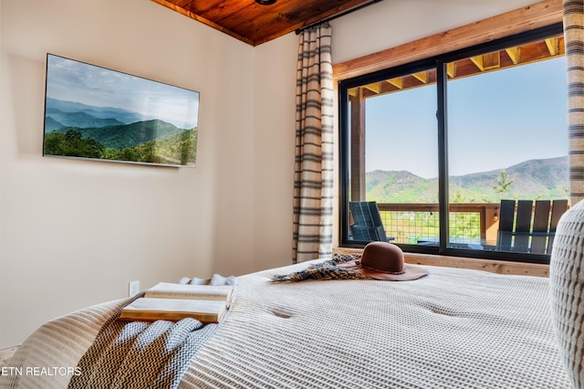 bedroom with a mountain view and wood ceiling