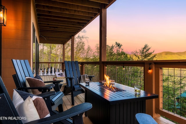 wooden terrace featuring a fire pit