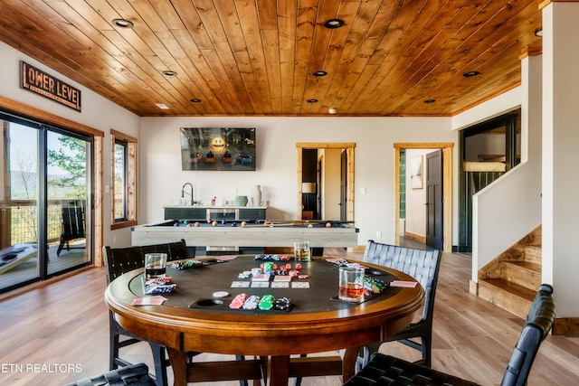 dining room featuring wooden ceiling, wood finished floors, and stairway