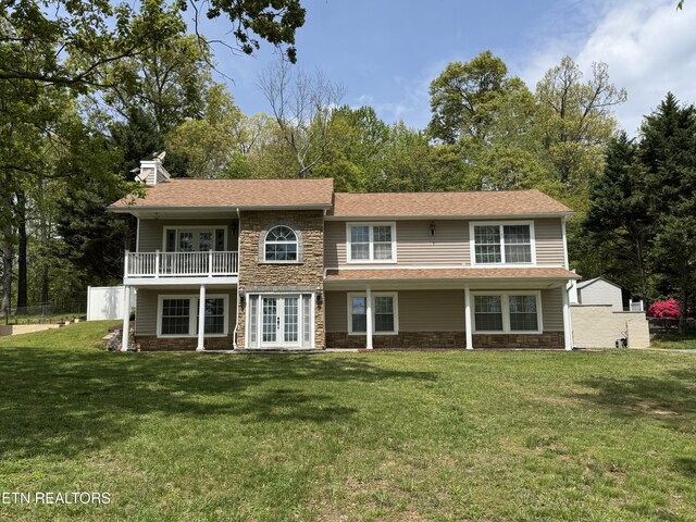 11709 Black Powder Dr, Knoxville, TN 37934 - back of property with a yard, stone siding, and french doors