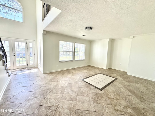 11709 Black Powder Dr, Knoxville, TN 37934 - interior space with baseboards, stone finish floor, a textured ceiling, and a healthy amount of sunlight