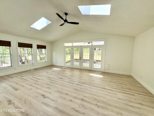11709 Black Powder Dr, Knoxville, TN 37934 - interior space featuring light wood finished floors, a ceiling fan, french doors, baseboards, and vaulted ceiling with skylight