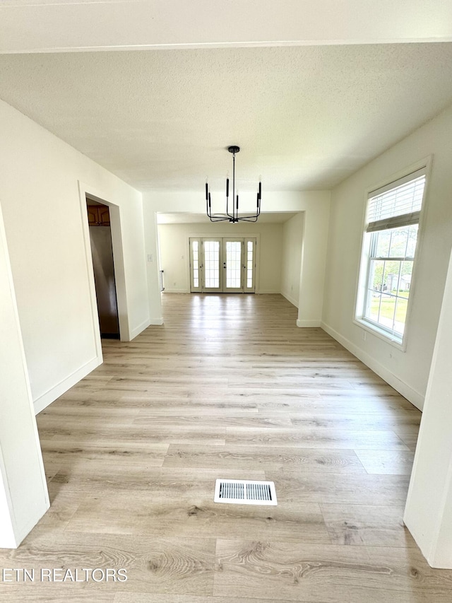11709 Black Powder Dr, Knoxville, TN 37934 - unfurnished dining area with baseboards, a notable chandelier, visible vents, and light wood-type flooring