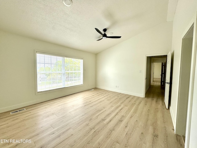 11709 Black Powder Dr, Knoxville, TN 37934 - unfurnished bedroom featuring a textured ceiling, light wood-type flooring, vaulted ceiling, baseboards, and visible vents