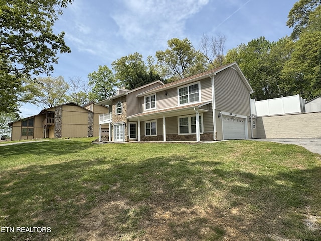 11709 Black Powder Dr, Knoxville, TN 37934 - traditional-style house featuring a front lawn, driveway, stone siding, an attached garage, and fence