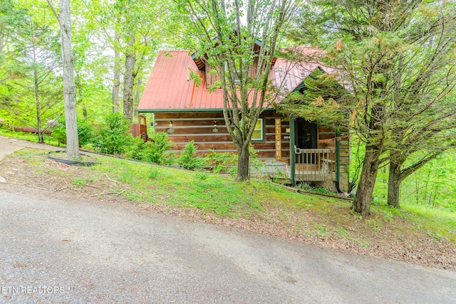 view of side of property featuring a barn and metal roof