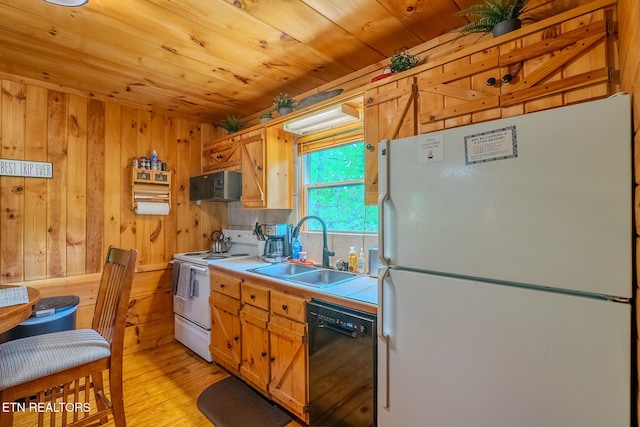 kitchen with a sink, tile counters, wood walls, wood ceiling, and black appliances