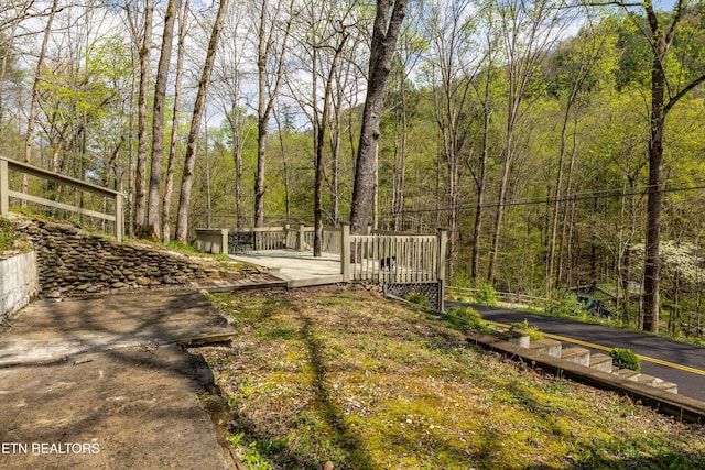 view of yard with a view of trees
