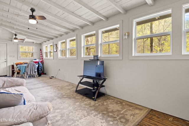 sunroom / solarium featuring beamed ceiling