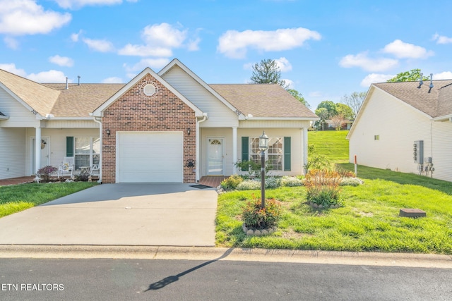 300 Willington Pl, Loudon, TN 37774 - view of front facade featuring roof with shingles, driveway, brick siding, a front yard, and a garage