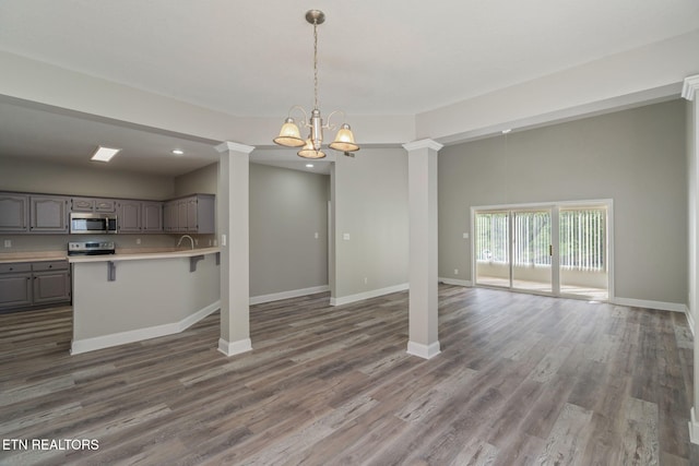 300 Willington Pl, Loudon, TN 37774 - unfurnished dining area featuring recessed lighting, wood finished floors, baseboards, decorative columns, and a notable chandelier