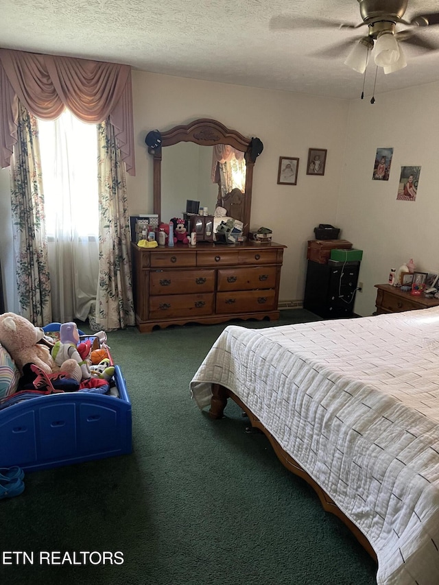 bedroom featuring a textured ceiling, carpet flooring, and ceiling fan
