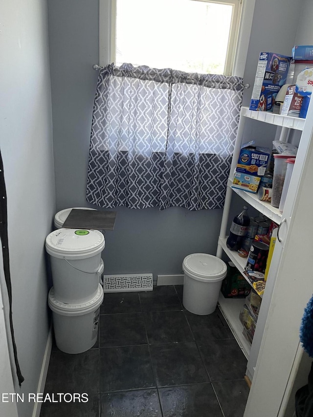 bathroom featuring visible vents, tile patterned flooring, and toilet