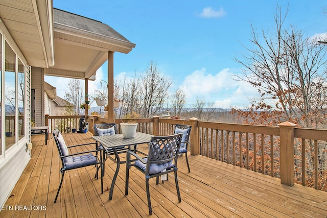 wooden deck featuring outdoor dining space