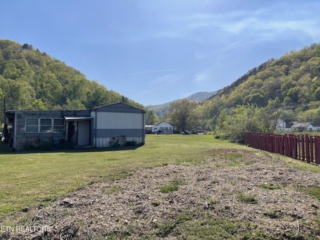 view of yard with fence and a mountain view