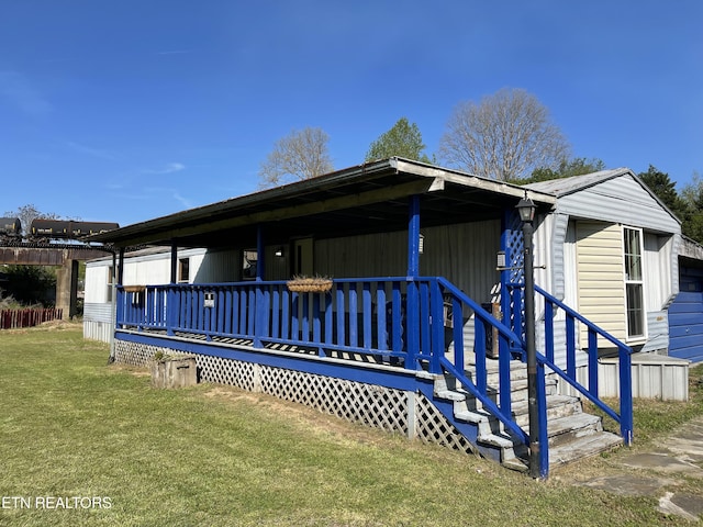 view of front of house featuring a front lawn and a wooden deck