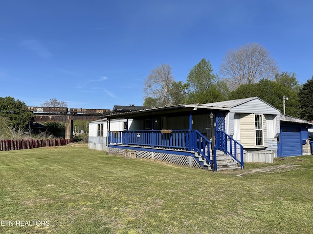view of front of home featuring a deck and a front yard