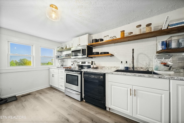 kitchen with stainless steel appliances, open shelves, visible vents, a sink, and decorative backsplash