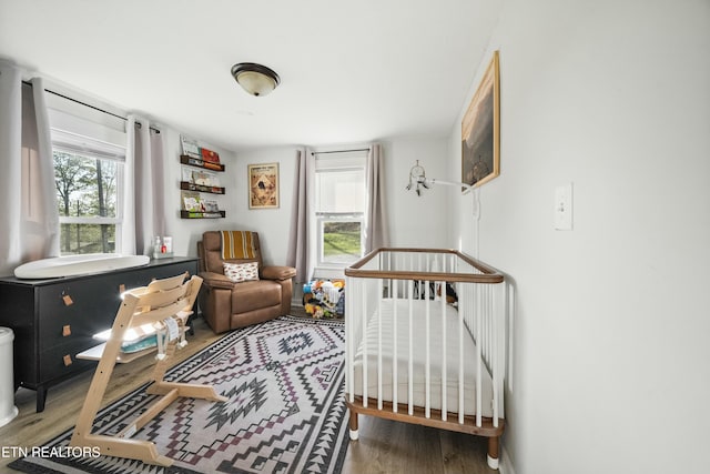 bedroom with wood finished floors and baseboards