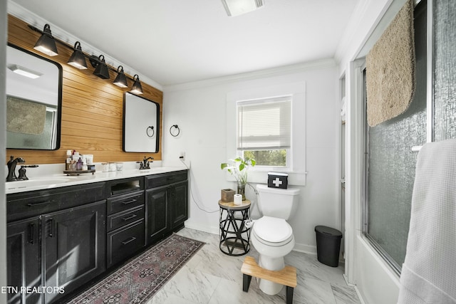 full bath featuring marble finish floor, toilet, a sink, and double vanity
