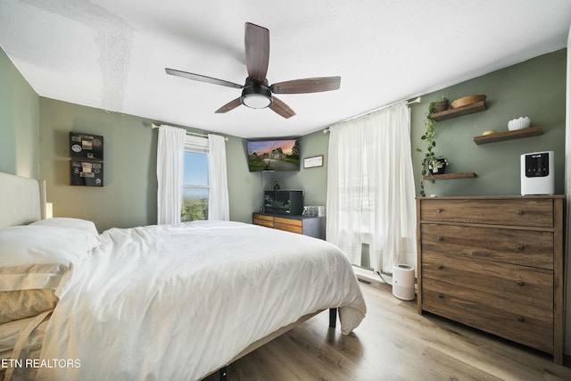 bedroom with wood finished floors and ceiling fan
