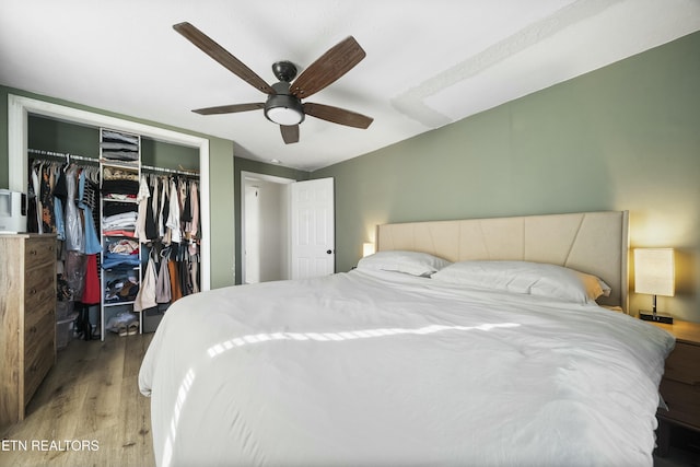 bedroom featuring wood finished floors, a closet, and ceiling fan