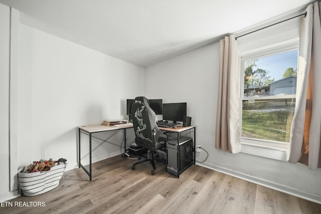 home office with baseboards and light wood finished floors