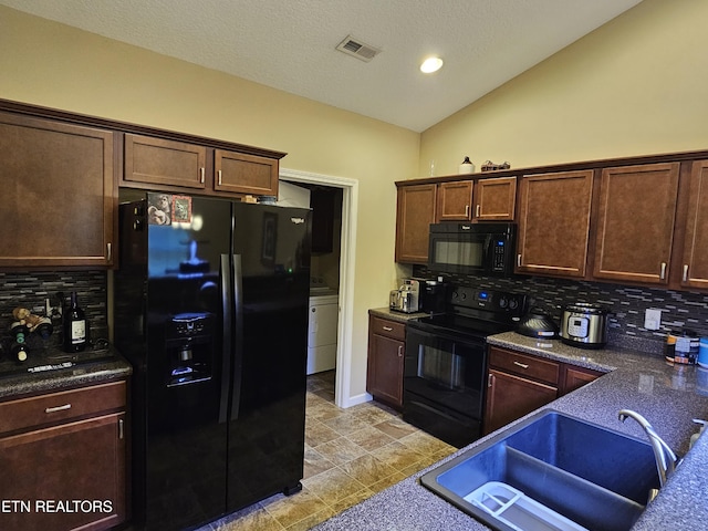 kitchen featuring a sink, dark countertops, visible vents, decorative backsplash, and black appliances