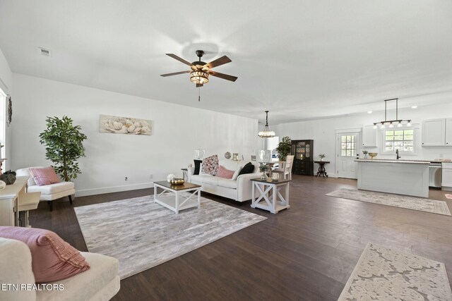 252 Old Middlesboro Hwy, Lafollette, TN 37766 - living area featuring baseboards, visible vents, dark wood-style floors, and ceiling fan with notable chandelier