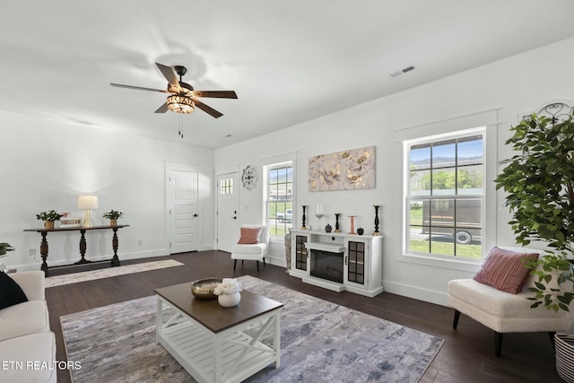 252 Old Middlesboro Hwy, Lafollette, TN 37766 - living area featuring visible vents, baseboards, wood finished floors, ceiling fan, and a fireplace