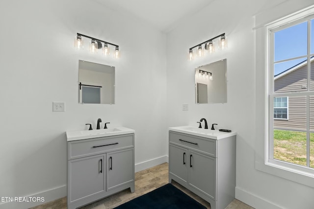 252 Old Middlesboro Hwy, Lafollette, TN 37766 - bathroom featuring two vanities, baseboards, and a sink