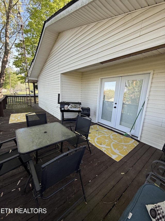 deck with french doors and a grill
