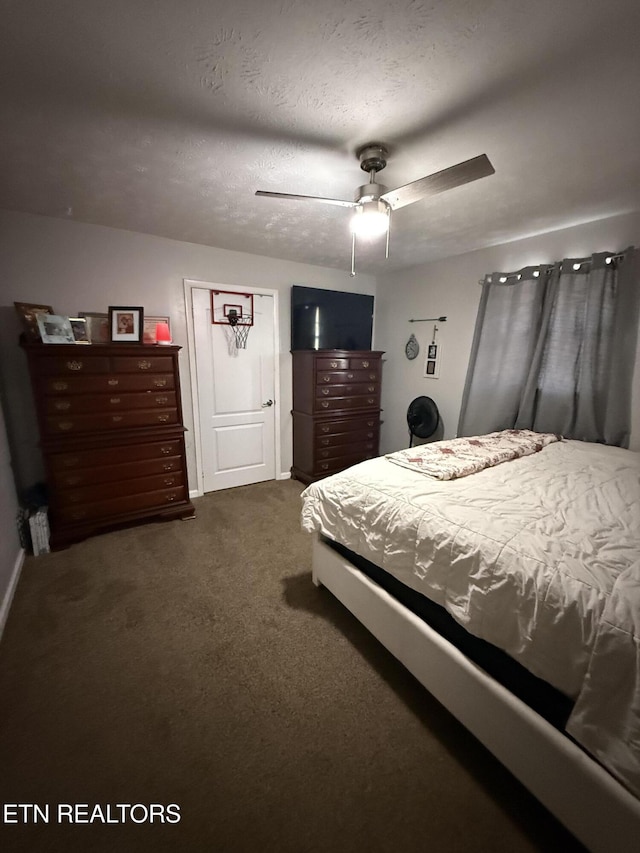bedroom with dark carpet, baseboards, and ceiling fan