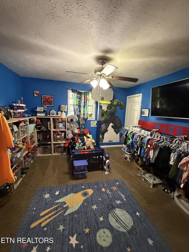 carpeted bedroom featuring a textured ceiling and ceiling fan