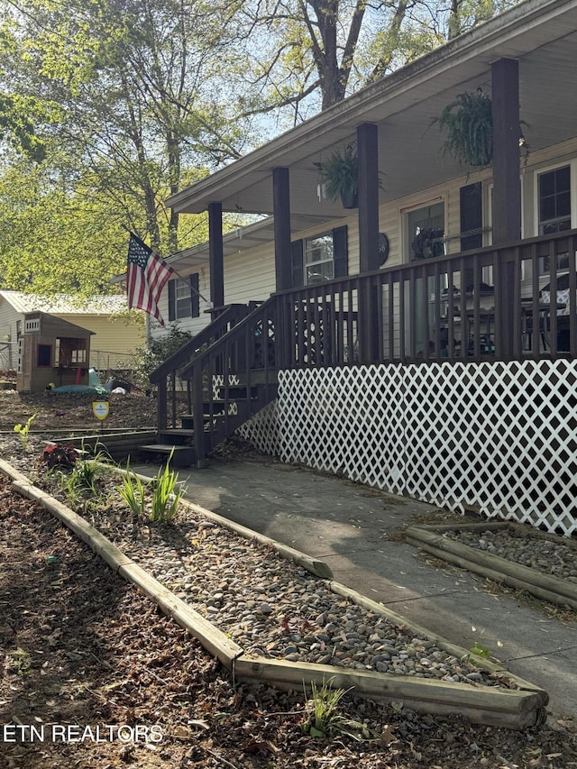 back of property featuring a porch