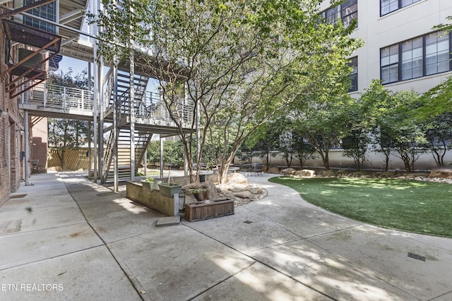 view of patio with stairway and fence