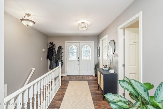 entryway featuring visible vents, baseboards, and dark wood-style flooring