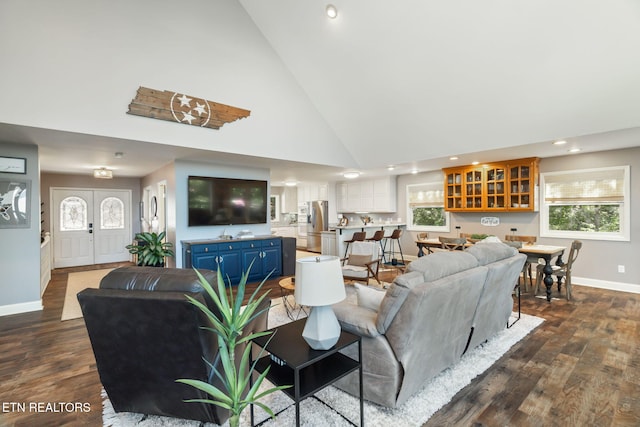 living room with dark wood-style floors, a healthy amount of sunlight, baseboards, recessed lighting, and high vaulted ceiling