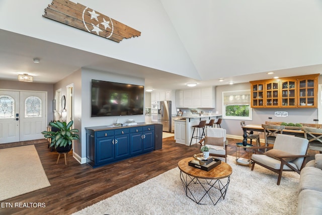 living area featuring recessed lighting, baseboards, high vaulted ceiling, and dark wood-type flooring