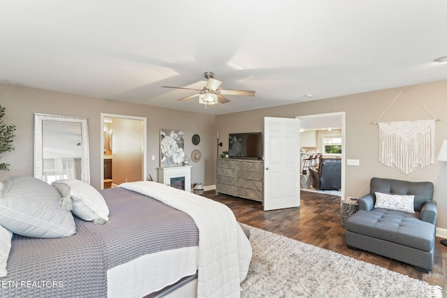 bedroom with ceiling fan, baseboards, and dark wood-style flooring