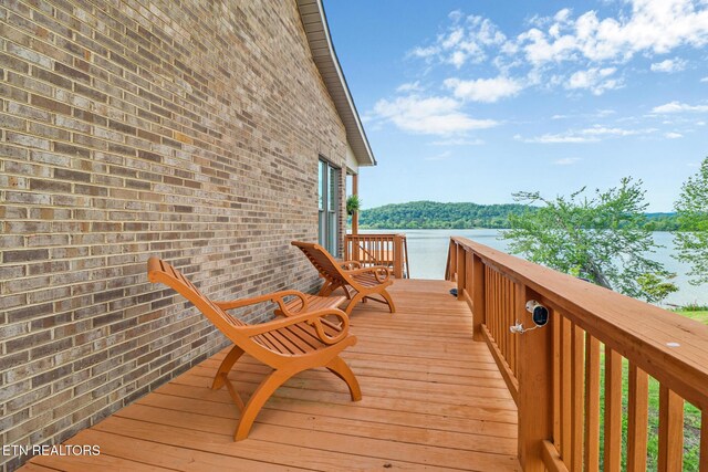 wooden deck featuring a water view