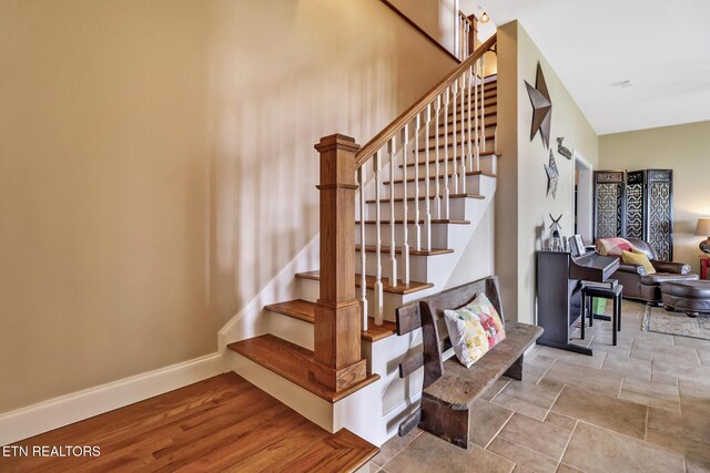 stairway featuring baseboards