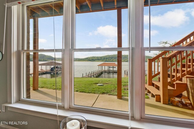 doorway featuring a water view and stairs