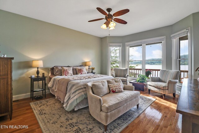 bedroom with baseboards, wood finished floors, ceiling fan, and access to exterior